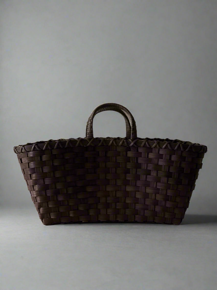 Brown woven basket on a light gray background