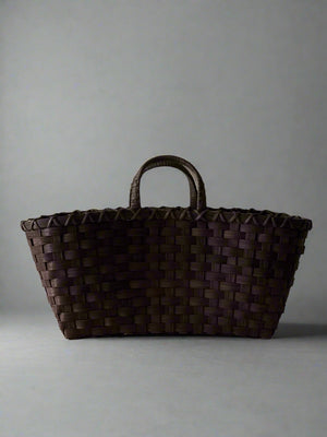 Brown woven basket on a light gray background