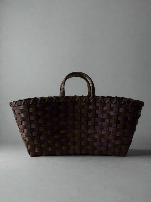 Brown woven basket on a light gray background