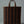 Woven brown bag with handles on a light gray background
