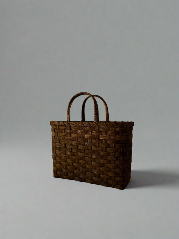 Woven brown bag on a white background