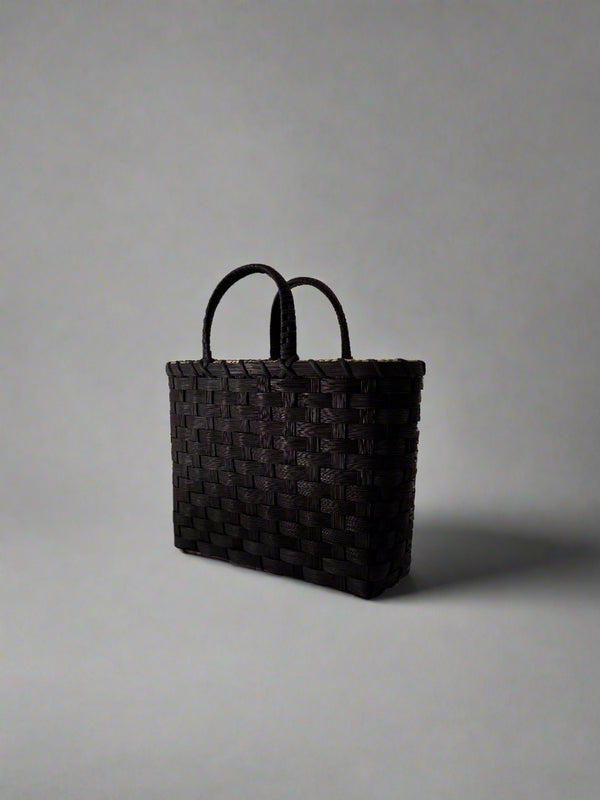 Black woven bag on a white background