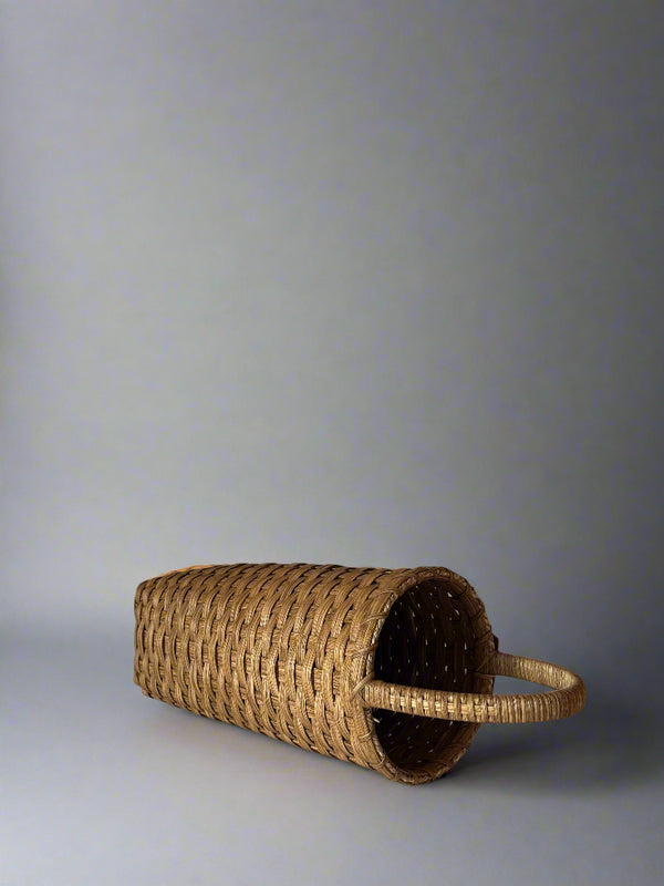 Woven basket with handles on a plain background