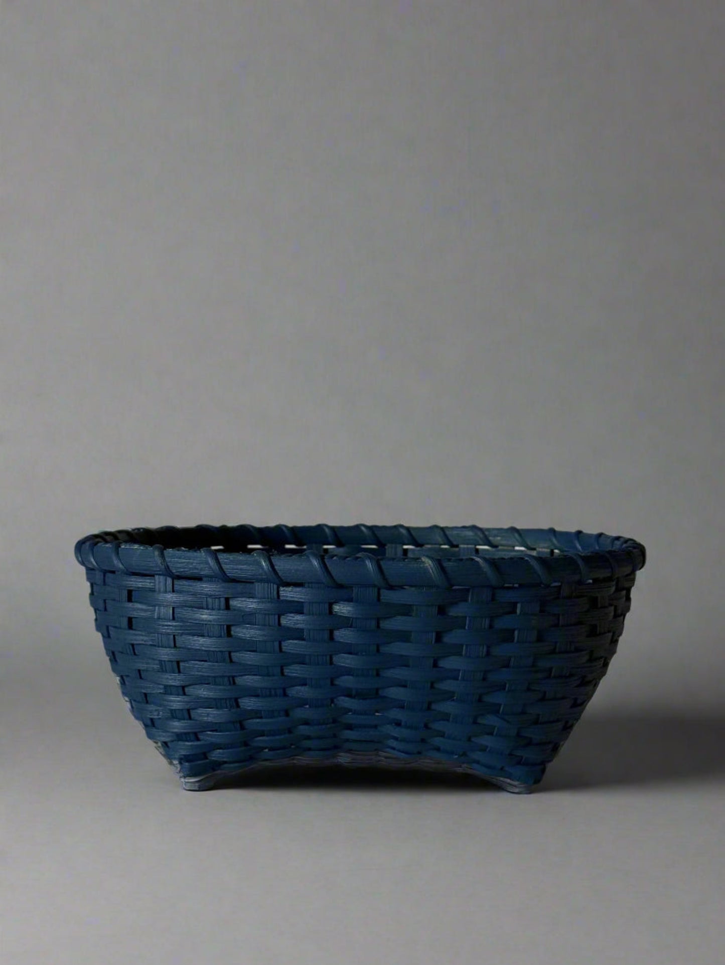 Blue woven basket on a light gray background