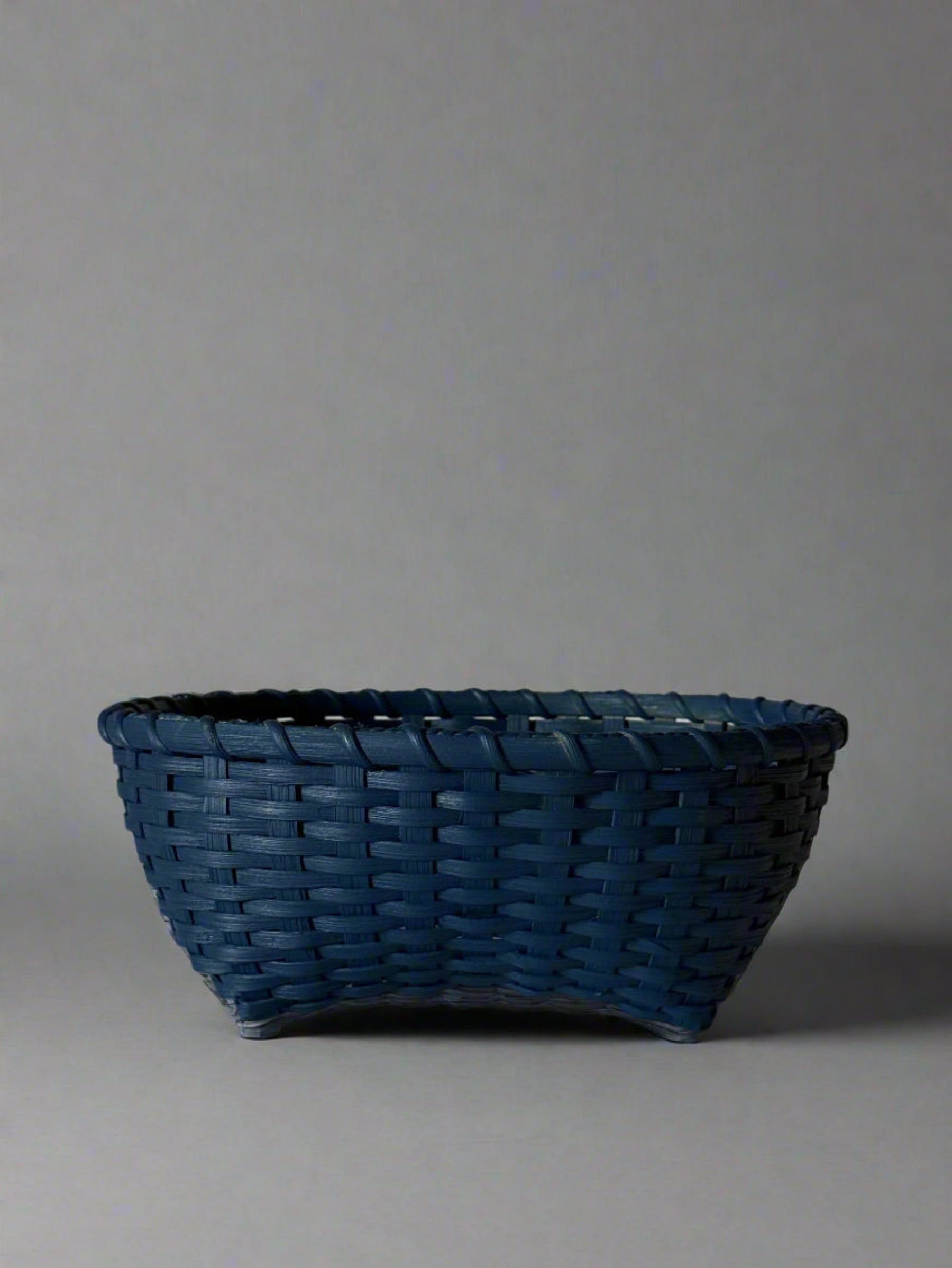 Blue woven basket on a light gray background