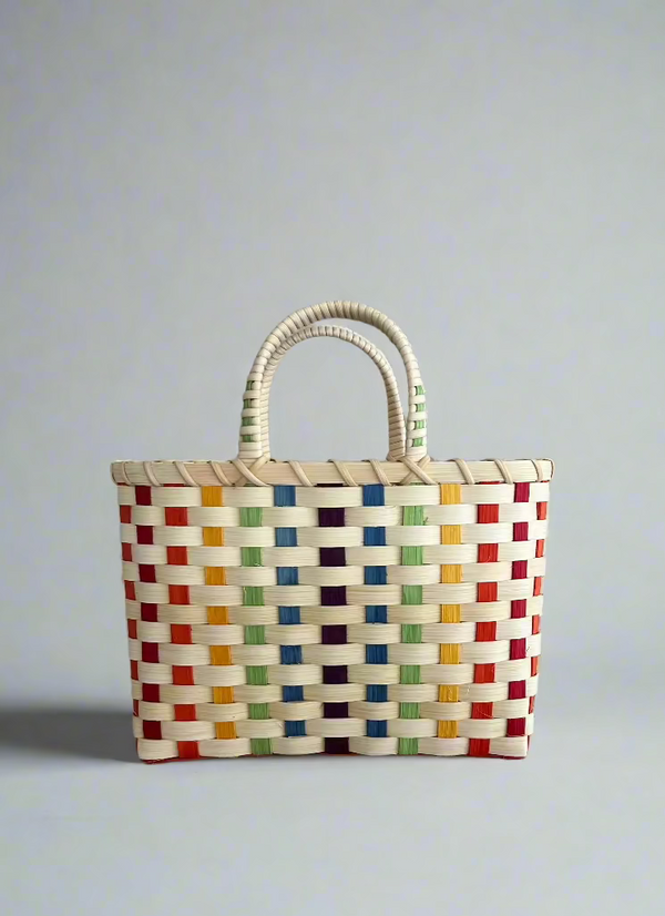 Colorful woven basket on a gray surface with a neutral background