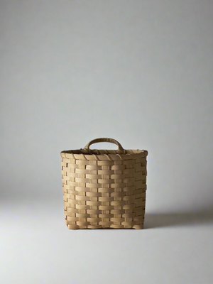 A small woven storage container, known as a Trail Basket, displayed against a neutral background.