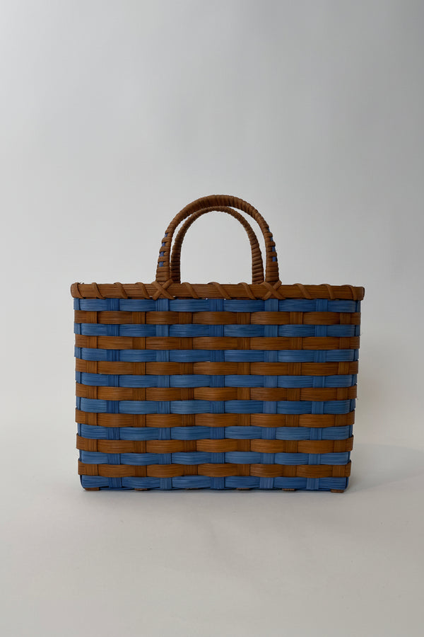 Woven tote bag with brown and blue stripes on a light gray background