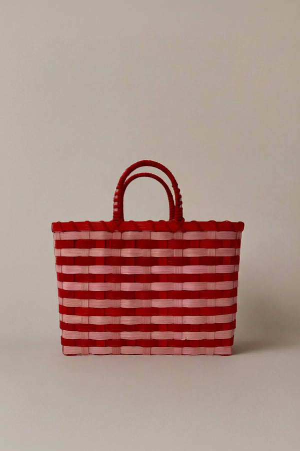 Red and white striped woven bag on a beige background