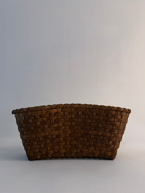 Woven brown basket on a light gray background