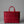 Red woven bag on a gray background