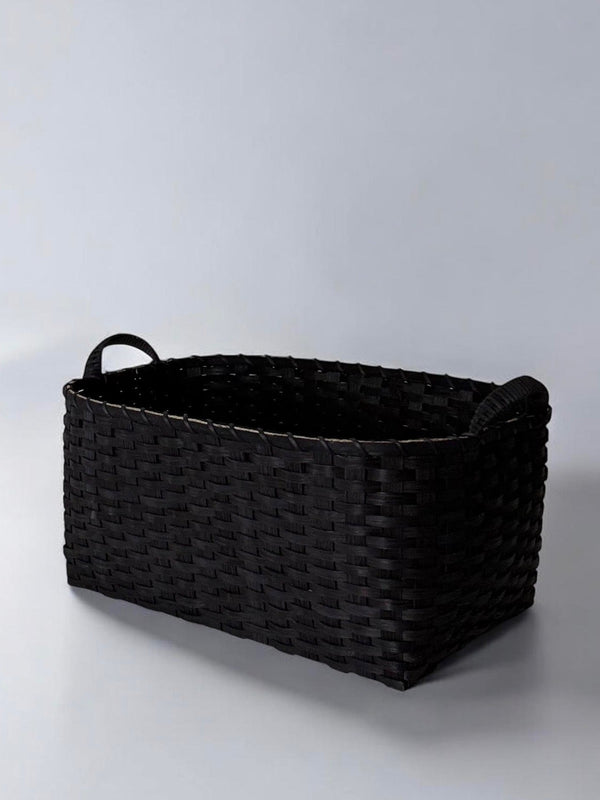 Black woven basket on a light gray background